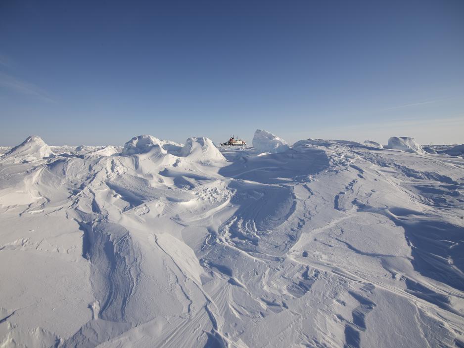 MOSAiC. Photo Michael Gutsche. Arctic ice dominating the picture in the front with small Polarstern on the horizon